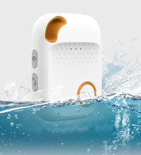 A Halo Personal GPS SOS Alarm device partially submerged in water, demonstrating its waterproof rating. The device's orange SOS button and orange accent near the top are visible, along with two side buttons. Water splashes around the device, emphasising its water-resistant feature.